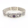 Multistrand silver bracelet with square woven chains, curved scrollwork panel, oval garnet and decorated box clasp