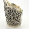 Wide peaked silver cuff with three crowned celestial dancers, openwork leafy scrolls and a rounded longevity medallion