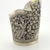 Wide peaked silver cuff with three crowned celestial dancers, openwork leafy scrolls and a rounded longevity medallion