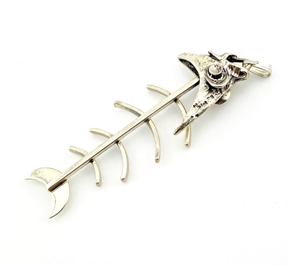 Vintage sterling silver fish skeleton pendant with cast head and articulated fabricated body