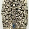 Wide peaked silver cuff with three crowned celestial dancers, openwork leafy scrolls and a rounded longevity medallion