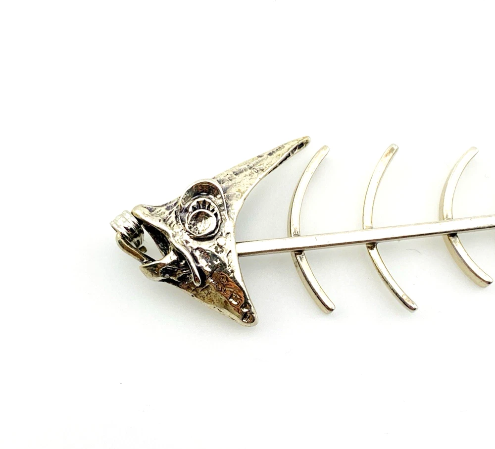 Vintage sterling silver fish skeleton pendant with cast head and articulated fabricated body