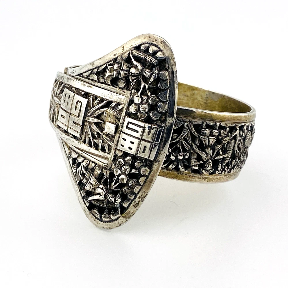 Chinese export silver buckle bracelet with pierced bamboo, flowers, figures and raised Chinese characters